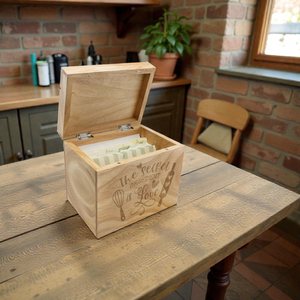 Wooden box with engraved design on a rustic wooden table