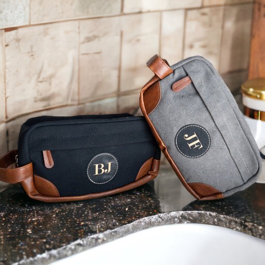 Durable canvas Hanging Dopp Kit, highlighting its spacious compartments and the unique, personalized touch of a leather patch.