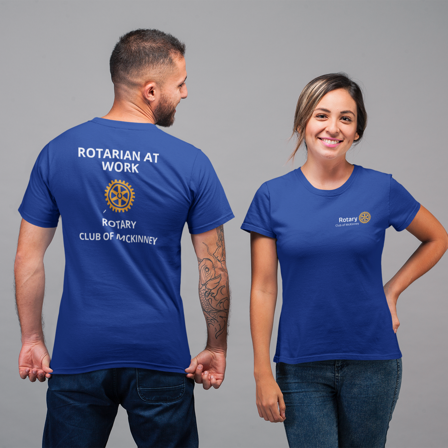Two people wearing blue Rotary shirts with text on a gray background