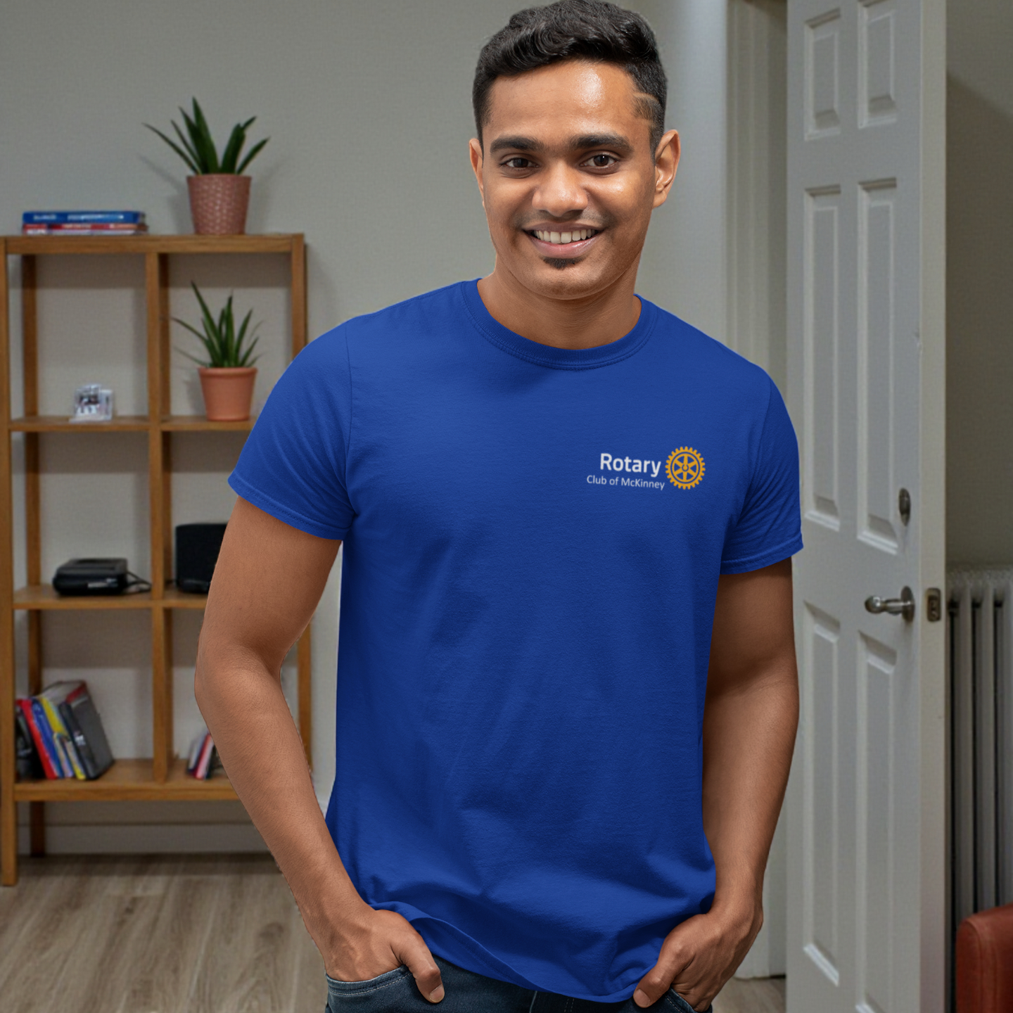 Man wearing a blue t-shirt with a Rotary logo in an indoor setting