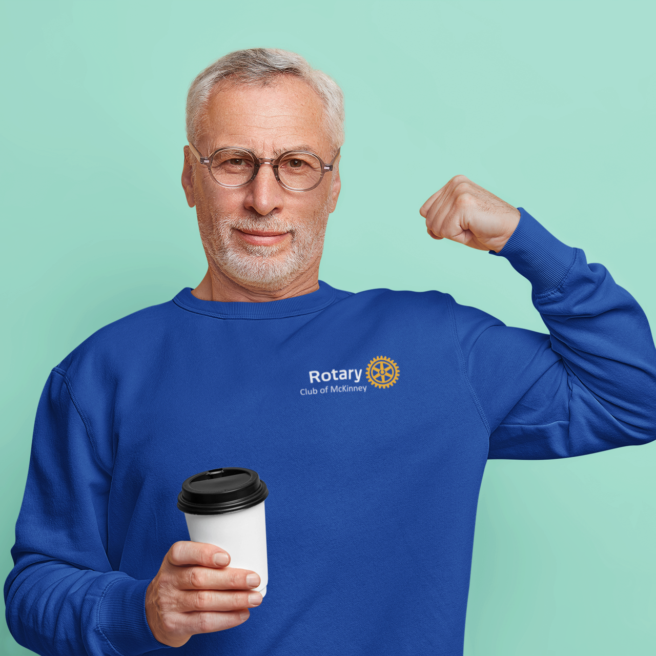 Man wearing a blue Rotary sweatshirt holding a coffee cup against a light green background
